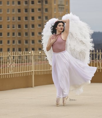a pair of angel wings on a dancer on the top floor of the Crazy Water Hotel