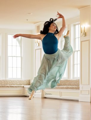 dancer in the Crazy Water Hotel ball room in flowing green skirt