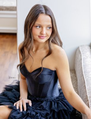 soft window light portrait of young dancer in dark blue dress