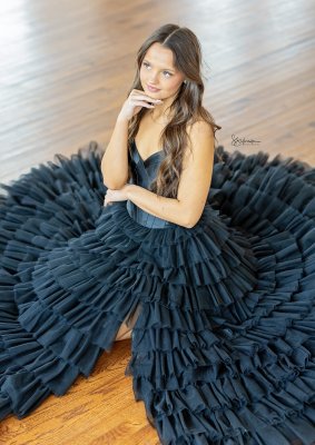 young lady surrounded by dark blue dress from an overhead perspective